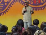 A Project YANO volunteer at a high school assembly.